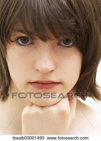 Stock Image - "Girl, teenager, chin propped up on fingers, portrait". Fotosearch