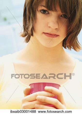 Stock Photo - "Girl, teenager, holding a cup". Fotosearch