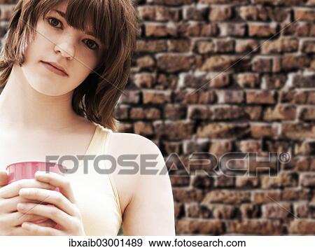 Stock Photo - "Girl, teenager, holding a cup". Fotosearch
