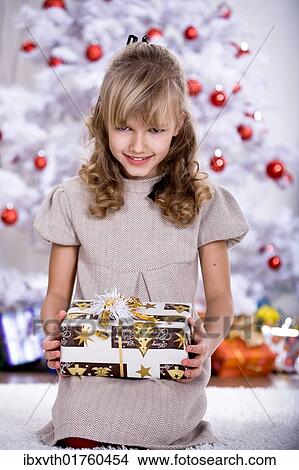 Girl unpacking Christmas gifts View Large Photo Image Picture - Girl unpacking Christmas gifts. Fotosearch