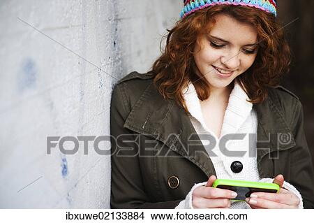 Girl using a mobile phone View Large Photo Image Picture - Girl using a mobile phone. Fotosearch