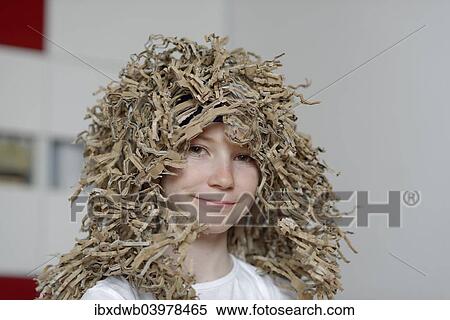 Stock Photography - Girl wearing a wig made from cardboard packaging. Fotosearch