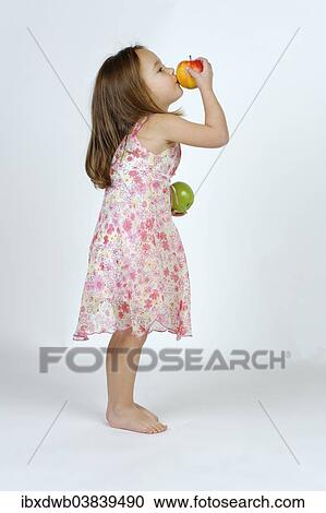 Girl with a red and a green apple View Large Photo Image Stock Image - Girl with a red and a green apple. Fotosearch