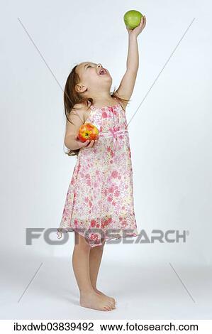 Girl with a red and a green apple View Large Photo Image Stock Image - Girl with a red and a green apple. Fotosearch