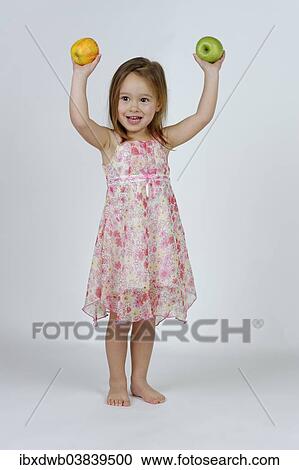 Girl with a red and a green apple View Large Photo Image Stock Image - Girl with a red and a green apple. Fotosearch
