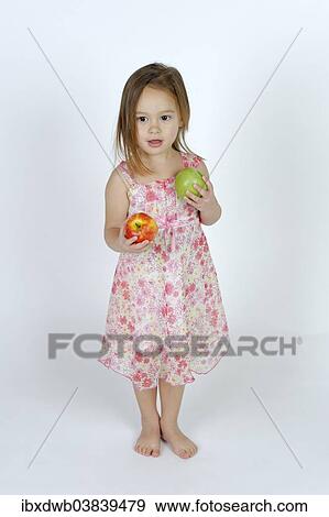 Girl with a red and a green apple View Large Photo Image Stock Photo - Girl with a red and a green apple. Fotosearch