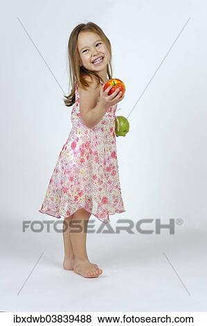 Girl with a red and a green apple View Large Photo Image Stock Photo - Girl with a red and a green apple. Fotosearch