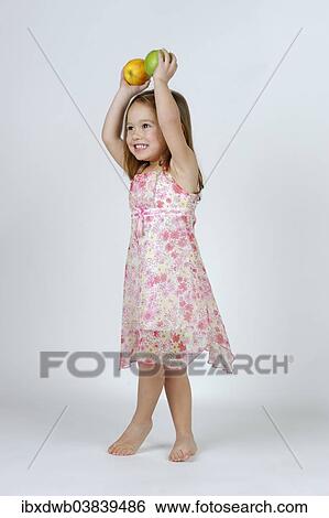 Girl with a red and a green apple View Large Photo Image Stock Photograph - Girl with a red and a green apple. Fotosearch