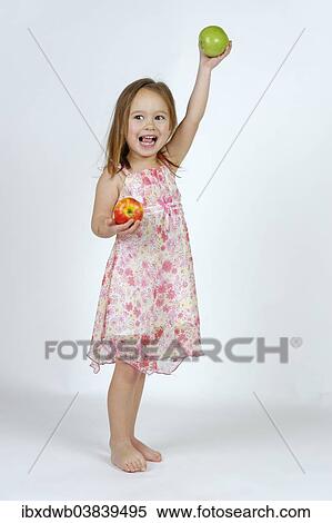 Girl with a red and a green apple View Large Photo Image Stock Photography - Girl with a red and a green apple. Fotosearch