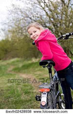 Girl with bicycle View Large Photo Image Stock Photo - Girl with bicycle. Fotosearch