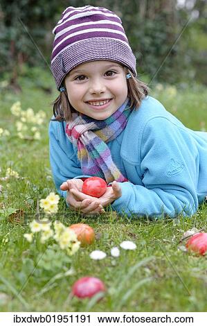 Girl with easter eggs in a spring meadow View Large Photo Image Stock Image - Girl with easter eggs in a spring meadow. Fotosearch