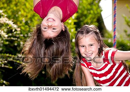 Stock Image - Girls playing on the playground. Fotosearch