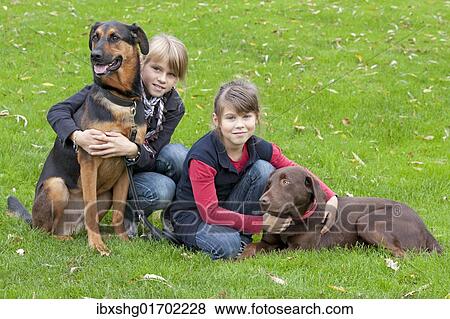 Girls with German Shepherd mix and Labrador View Large Photo Image Stock Photo - Girls with German Shepherd mix and Labrador. Fotosearch