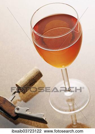 Glass of rose wine beside a corkscrew with a cork View Large Photo Image Stock Image - Glass of rose wine beside a corkscrew with a cork. Fotosearch