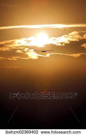 Stock Image - Glider at sunset. Fotosearch