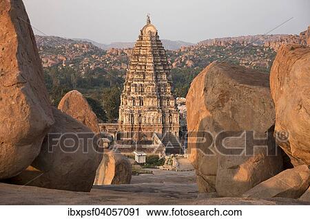 Stock Image - "Granite rocks and Gopuram of the Virupaksha Temple, Hampi, Karnataka, India, Asia". Fotosearch