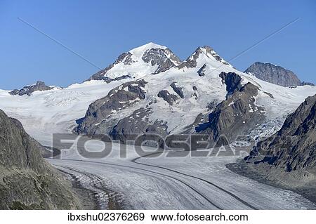 Stock Photo - "Great Aletsch glacier, behind Mt. Eiger, Mt. Moench and Mt. Jungfrau, UNESCO World Heritage Site Swiss Alps Jungfrau-Aletsch, Goms, Valais, Switzerland, Europe". Fotosearch