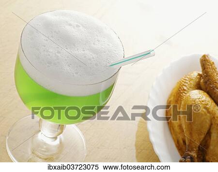 Stock Photography - "Green Berliner Weisse beer next to a grilled chicken, Germany, Europe". Fotosearch