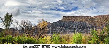 Stock Image - "Green fertile valley with the South Caineville Mesa after a thunderstorm, Caineville, Utah, United States, North America". Fotosearch