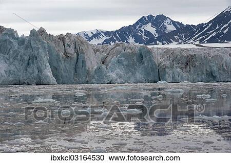 Stock Image - "Green shimmering glacier front of Kongsbreen, Kongsfjorden, Ny-Alesund, Spitsbergen Island, Svalbard Archipelago, Svalbard and Jan Mayen, Norway, Europe". Fotosearch