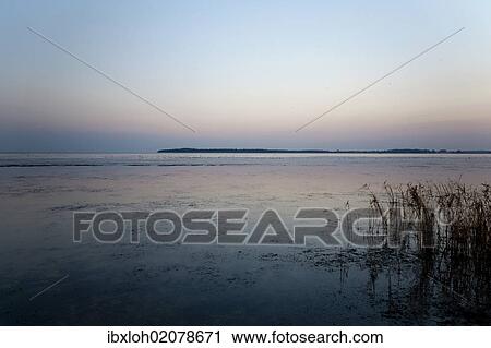 Stock Image - "Greifswalder Bodden, Bay of Greifswald, at dusk, Greifswald, Mecklenburg-Western Pomerania, Germany, Europe". Fotosearch