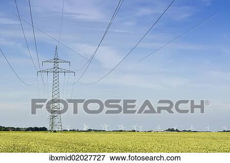 Stock Photo - "Grid connection and electricity feed-in of onshore wind energy, 110 kV high-voltage electricity line in the Gotteskoog polder near Niebuell, a wind farm at the back, district of North Frisia, Schleswig-Holstein, Germany, Europe". Fotosearch