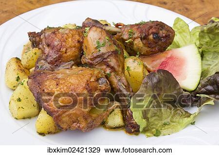 Stock Photo - Grilled chicken with fried potatoes. Fotosearch