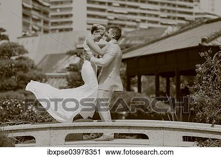 Groom lifting the bride up in the air View Large Photo Image Stock Image - Groom lifting the bride up in the air. Fotosearch