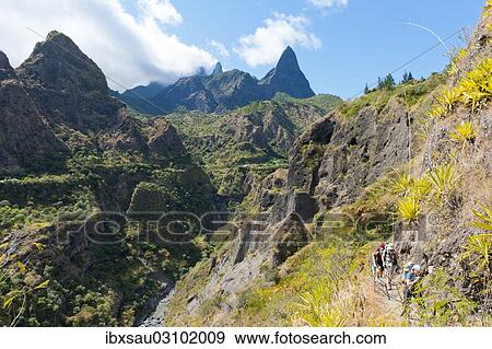 "Group of hikers hiking in the rugged mountain landscape, Ilet des Lataniers, Cirque de Mafate, Reunion National Park, Reunion" View Large Photo Image Stock Photo - "Group of hikers hiking in the rugged mountain landscape, Ilet des Lataniers, Cirque de Mafate, Reunion National Park, Reunion". Fotosearch