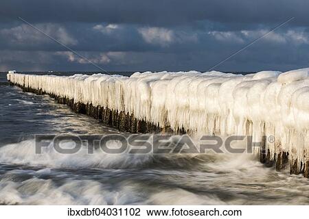 Stock Image - "Groynes covered with snow and icicles, Baltic Sea, Zingst, Fischland-Darss-Zingst, Mecklenburg-Western Pomerania, Germany, Europe". Fotosearch