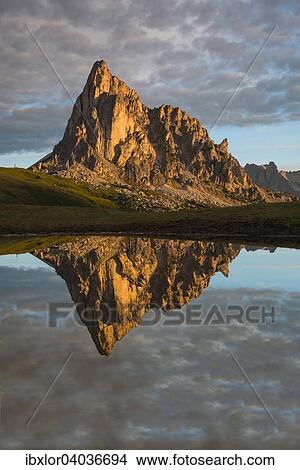"Gusela mountain at sunrise reflected in small lake, Giau Pass, Dolomites, Veneto, Italy, Europe" View Large Photo Image Picture - "Gusela mountain at sunrise reflected in small lake, Giau Pass, Dolomites, Veneto, Italy, Europe". Fotosearch