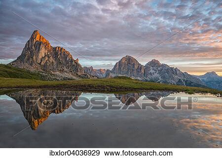 "Gusela mountain at sunrise reflected in small lake, Giau Pass, Dolomites, Veneto, Italy, Europe" View Large Photo Image Stock Photo - "Gusela mountain at sunrise reflected in small lake, Giau Pass, Dolomites, Veneto, Italy, Europe". Fotosearch