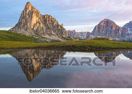 "Gusela mountain at sunrise reflected in small lake, Giau Pass, Dolomites, Veneto, Italy, Europe" View Large Photo Image Stock Photography - "Gusela mountain at sunrise reflected in small lake, Giau Pass, Dolomites, Veneto, Italy, Europe". Fotosearch