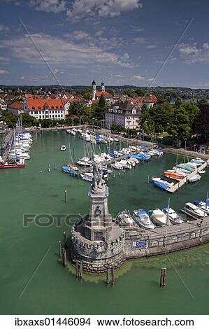 Picture - "Harbor entrance with the Bavarian lion seen from the lighthouse, harbor and the downtown Lindau, Lake Constance, Bavaria, Germany, Europe". Fotosearch