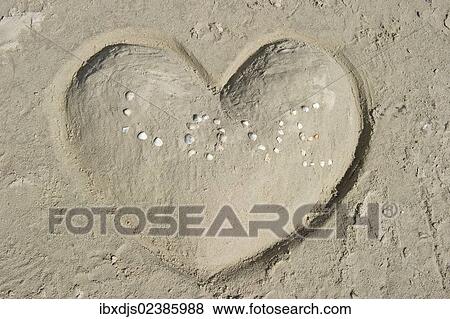 "Heart made of sand with the word LOVE made of shells, St Peter-Ording, North Frisia, Schleswig-Holstein, Germany, Europe" View Large Photo Image Stock Photo - "Heart made of sand with the word LOVE made of shells, St Peter-Ording, North Frisia, Schleswig-Holstein, Germany, Europe". Fotosearch