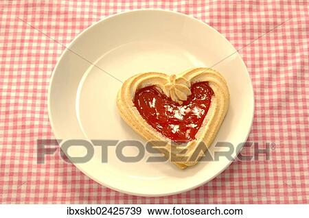 Stock Photo - Heart-shaped biscuit on a plate. Fotosearch