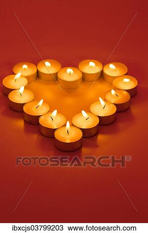 "Heart-shaped tealights, burning" View Large Photo Image Stock Image - "Heart-shaped tealights, burning". Fotosearch