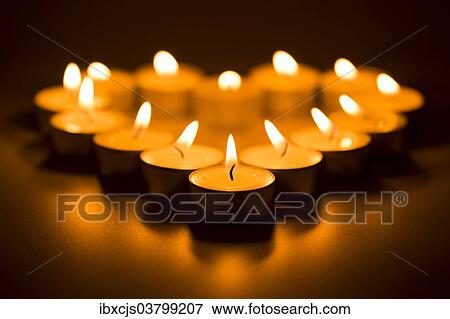 Stock Photo - "Heart-shaped tealights, burning". Fotosearch