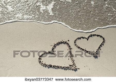Hearts drawn in the sand View Large Photo Image Stock Photo - Hearts drawn in the sand. Fotosearch