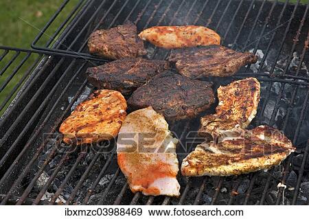 Heavily roasted meat on a charcoal grill View Large Photo Image Stock Photo - Heavily roasted meat on a charcoal grill. Fotosearch