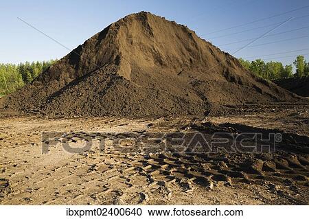 "Heavy tire tracks and a mound of topsoil in a commercial sandpit, Quebec, Canada, North America" View Large Photo Image Stock Image - "Heavy tire tracks and a mound of topsoil in a commercial sandpit, Quebec, Canada, North America". Fotosearch