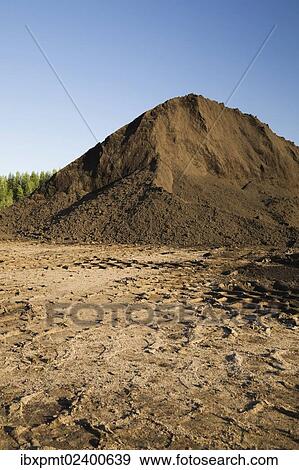"Heavy tire tracks and a mound of topsoil in a commercial sandpit, Quebec, Canada, North America" View Large Photo Image Stock Photo - "Heavy tire tracks and a mound of topsoil in a commercial sandpit, Quebec, Canada, North America". Fotosearch