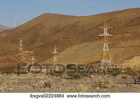 Picture - "High voltage cables with red and white pylons crossing the barren slopes of the Al Hajar Mountains, Sultanate of Oman, Middle East, Asia". Fotosearch