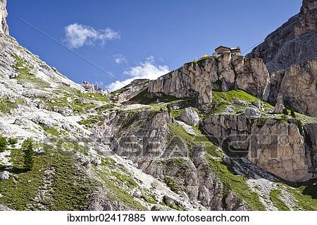 Stock Photography - "Hiker climbing Kesselkogel mountain, Rifugio Preuss mountain shelter at the back, province of Trento, Italy, Europe". Fotosearch