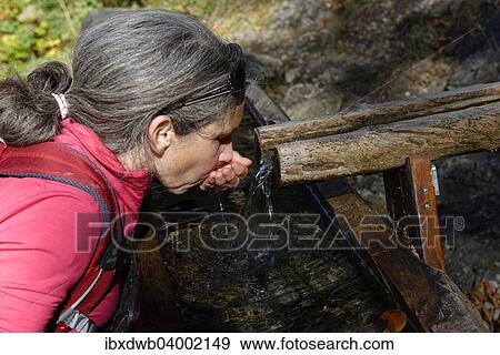 "Hiker drinking water at a fountain, Upper Bavaria, Bavaria, Germany, Europe" View Large Photo Image Stock Photo - "Hiker drinking water at a fountain, Upper Bavaria, Bavaria, Germany, Europe". Fotosearch