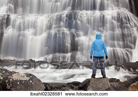 "Hiker in front of the Dynjandi waterfall, Fjallfoss, West Fjords, Iceland, Europe" View Large Photo Image Stock Image - "Hiker in front of the Dynjandi waterfall, Fjallfoss, West Fjords, Iceland, Europe". Fotosearch