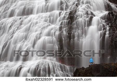 "Hiker in front of the Dynjandi waterfall, Fjallfoss, West Fjords, Iceland, Europe" View Large Photo Image Stock Image - "Hiker in front of the Dynjandi waterfall, Fjallfoss, West Fjords, Iceland, Europe". Fotosearch