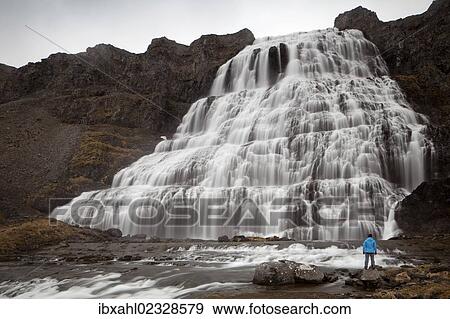 "Hiker in front of the Dynjandi waterfall, Fjallfoss, West Fjords, Iceland, Europe" View Large Photo Image Stock Photo - "Hiker in front of the Dynjandi waterfall, Fjallfoss, West Fjords, Iceland, Europe". Fotosearch