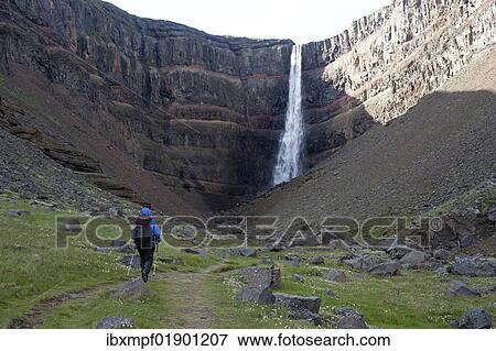 "Hiker in front of the Hengifoss waterfall, Egilsstadir, Iceland, Europe" View Large Photo Image Stock Photo - "Hiker in front of the Hengifoss waterfall, Egilsstadir, Iceland, Europe". Fotosearch