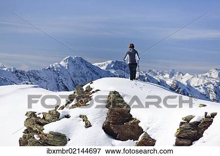 Stock Photo - "Hiker in the snow on the top of Roethenspitz Mountain above Penser Joch Pass, Sarn Valley, Alto Adige, Italy, Europe". Fotosearch